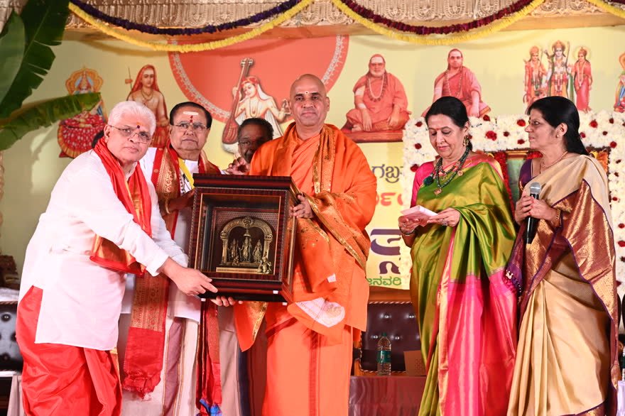 A framed image presented to the Acharya